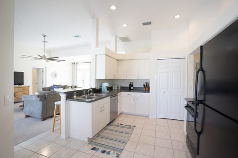 Open kitchen that looks out over the family room and pool