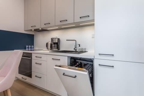 A dining and kitchen area, showcasing a blend of functionality and style, perfect for meals and gatherings.