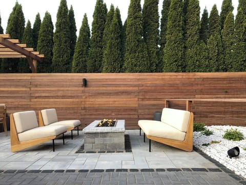 Shared patio with natural gas fire pit and teak patio furniture.