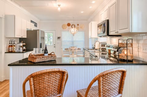 Open concept with a breakfast bar and beautiful lighting. 