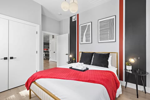 Inviting bedroom with a comfortable queen bed, bathed in soothing natural light, offering a tranquil space for a peaceful night's rest.




