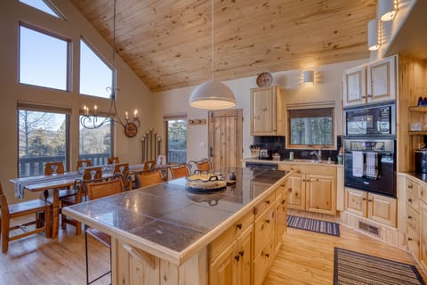 Kitchen with bar stools and dining room