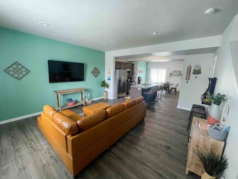 Open kitchen, living, dining room with patio access