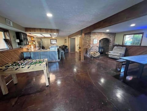 Daylight basement with tv room, bar, wood stove, farmhouse table (12) & games. 