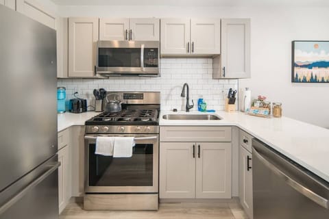 Updated well stocked kitchen with stainless steel appliances
