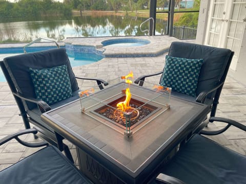 Fireside chats on the lanai with outdoor TV and bar