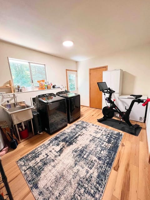 The laundry room is spacious and has a peloton.