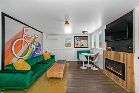 The ultimate chill zone with a fireplace, 9ft velvet sofa, and smart TV!