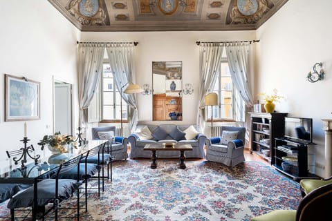 Spacious living room with plenty of seating overlooks inner courtyard.