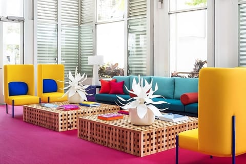 Stretch out with friends amid playful colors and airy windows.
