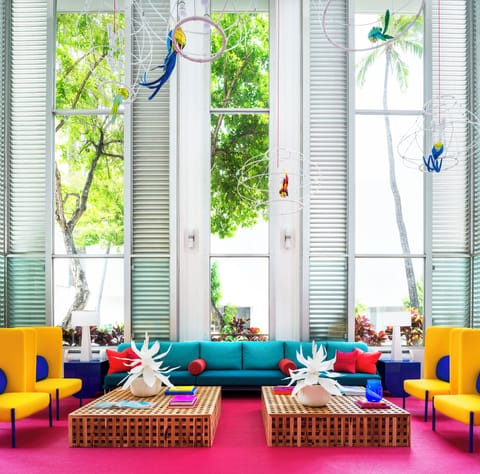 Gather on bold sofas in a sunlit, design-forward lounge.