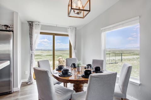 Dining area with seating for six and panoramic ranch views.