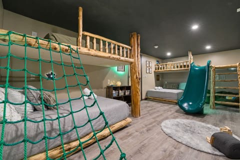 A kid’s dream come true! A bedroom with its own slide and climbing net.