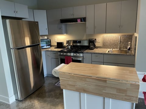 Kitchen with stove, refrigerator, microwaver.