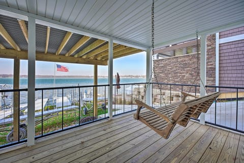 [Downstairs Covered Deck] Swinging chair available to relax in the shade.