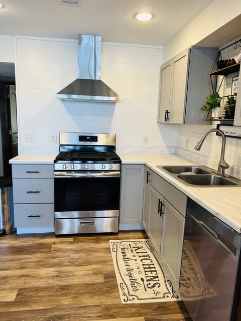 Kitchen features a 5 burner gas range. 