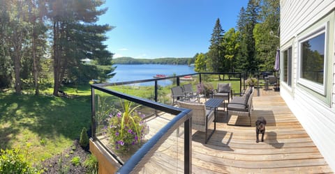 Entrance-Left hand side-wrap around deck with water, fire-pit, garden view.