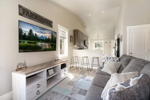 Walk into a comfortable bright living room that extends into a fully stocked kitchen.