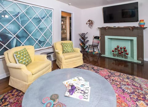 Large 60" TV in the living room. There are also TVs in each bedroom