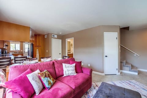 Living room and dining room continue to the kitchen. Pictured on the right side is storage closet, full guest bathroom and closed door to bedroom.