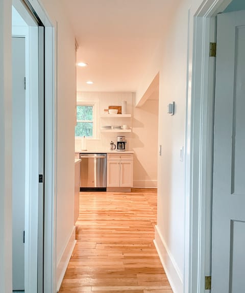 Bathroom, primary bedroom and twin bedroom are accessed off kitchen.
