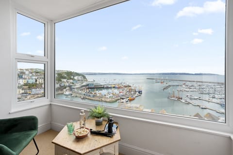 Living room window offering stunning views of Brixham harbour and beyond.
