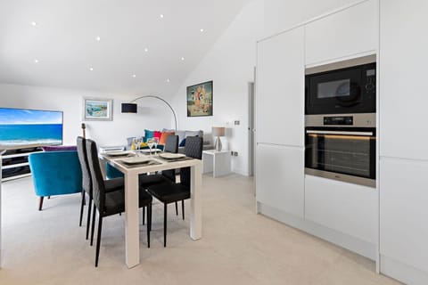 Stylish living room, dining area and kitchen