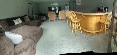 Second living room with 70” Samsung TV, recliners, sleeper sofa and huge couch