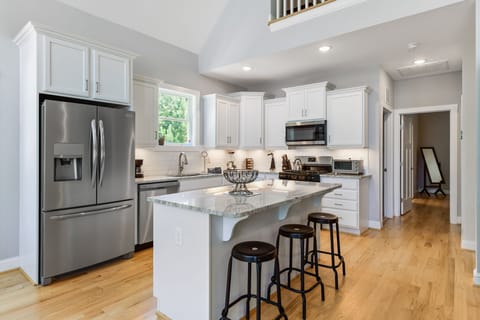 Stainless steel appliances, gas stove, microwave, island.  fully stocked kitchen