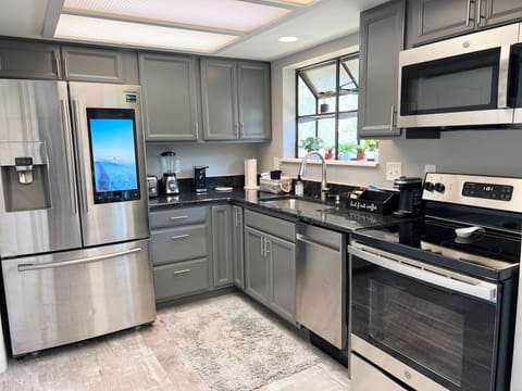 Full well-stocked kitchen with high-end stainless appliances.