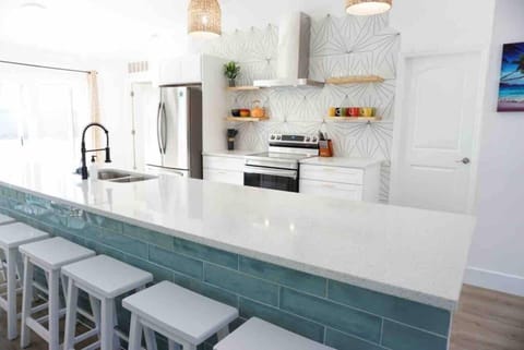 The open kitchen design features an island and plenty of room to prepare meals. 
