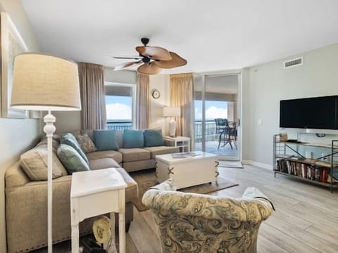 Relax in your spacious living room with comfortable sectional seating and stunning ocean views from your private balcony.