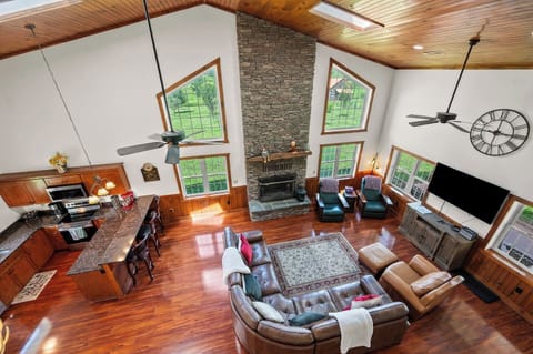 Open concept Great Room with tons of leather seating, kitchen bar and a family hearth.