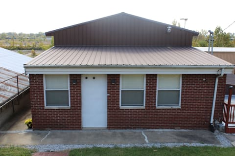 Entrance to the apartment is to the left where the flowers are.
