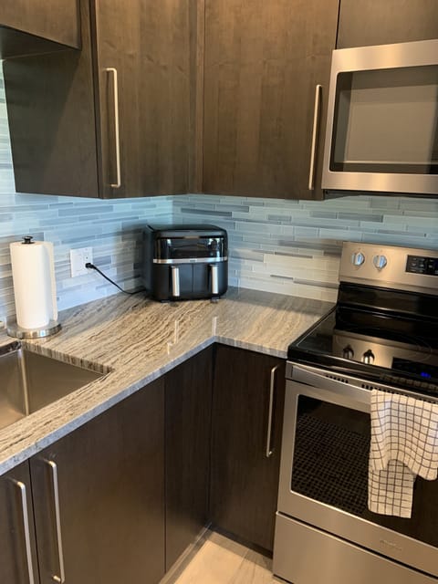 Kitchen has amenities like an air fryer, coffee station, Nutri Bullet & more!