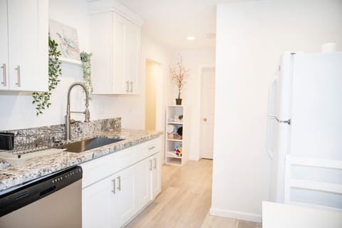 Plenty of cabinet space with dishware and silverware. Granite counters, stainless steel sink, dishwasher and full size refrigerator.