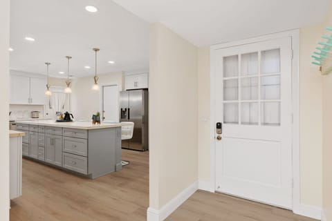 Oversized island in a well-lit chef's kitchen with seating for 9.