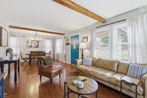 Comfortable and spacious seating area with a modern sofa, warm natural light, and charming Craftsman details—your ideal home base in Waldo KC.