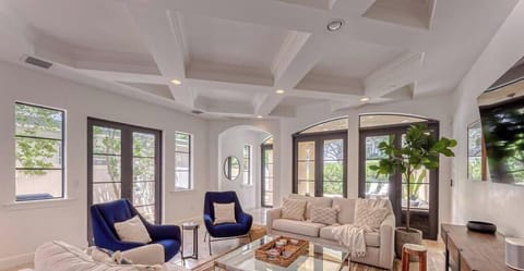 Open layout Living/Dining on 1st floor with plenty of seating to watch TV, Dining table for 10, overlooking outdoor patio / bbq & pool.