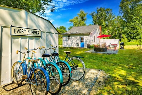 [Patio, Backyard] Lakeside bliss: Where cruiser bikes, firepit, and grill meet for the perfect retreat.