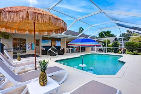 Enclosed pool area with loungers, perfect for relaxing in any weather.