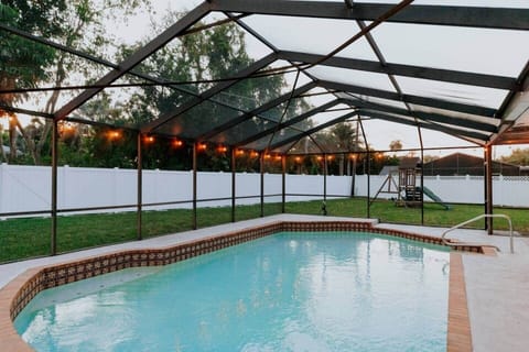 Bistro light-lined screened in lanai. The atmosphere gets even more cozy at night!