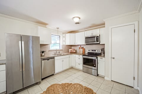 Fridge, dishwasher, oven/stove and microwave. Small pantry to the right. 
