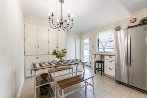 Kitchen layout w/ pantry/cabinet behind dining table. Rear is the laundry room. 