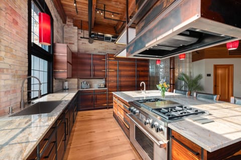 Large kitchen features granite, wolf appliances, and Sub Zero refrigerator