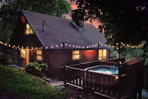 Backyard cabin view with hot tub and string lights to make your evenings magical