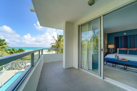 Breathe in palm-kissed air from bed beside bright windows.