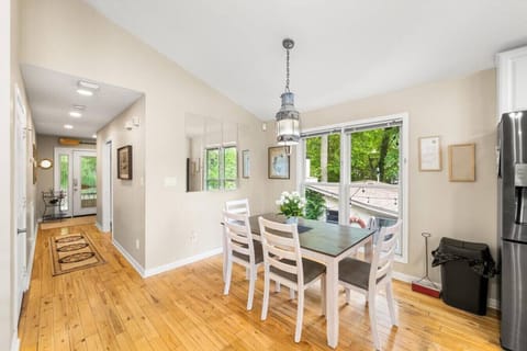 Dining table by a large window overlooking the second house