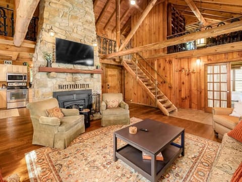 Cozy ambiance around the stunning stone fireplace in the living room.