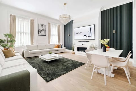 Living Room | A luxury retreat in our spacious living room with high ceilings, a 90 inch Smart LED TV, and full air conditioning for year round comfort. Relax in a perfectly curated, elegant setting with premium furnishings and a calm.